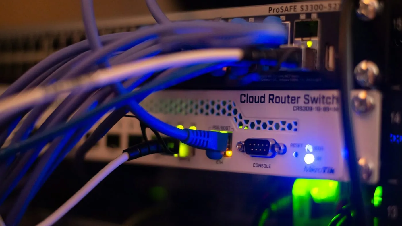 Network cables plugged into a lit router switch